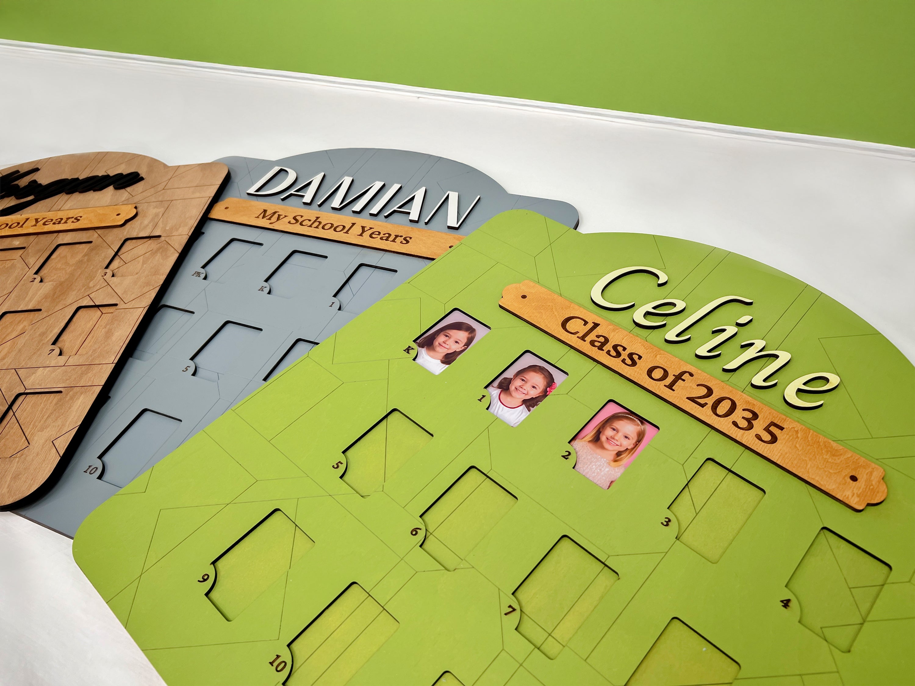 Handcrafted wooden picture frame displays with personalized names and school years, ideal for showcasing children's class photos.