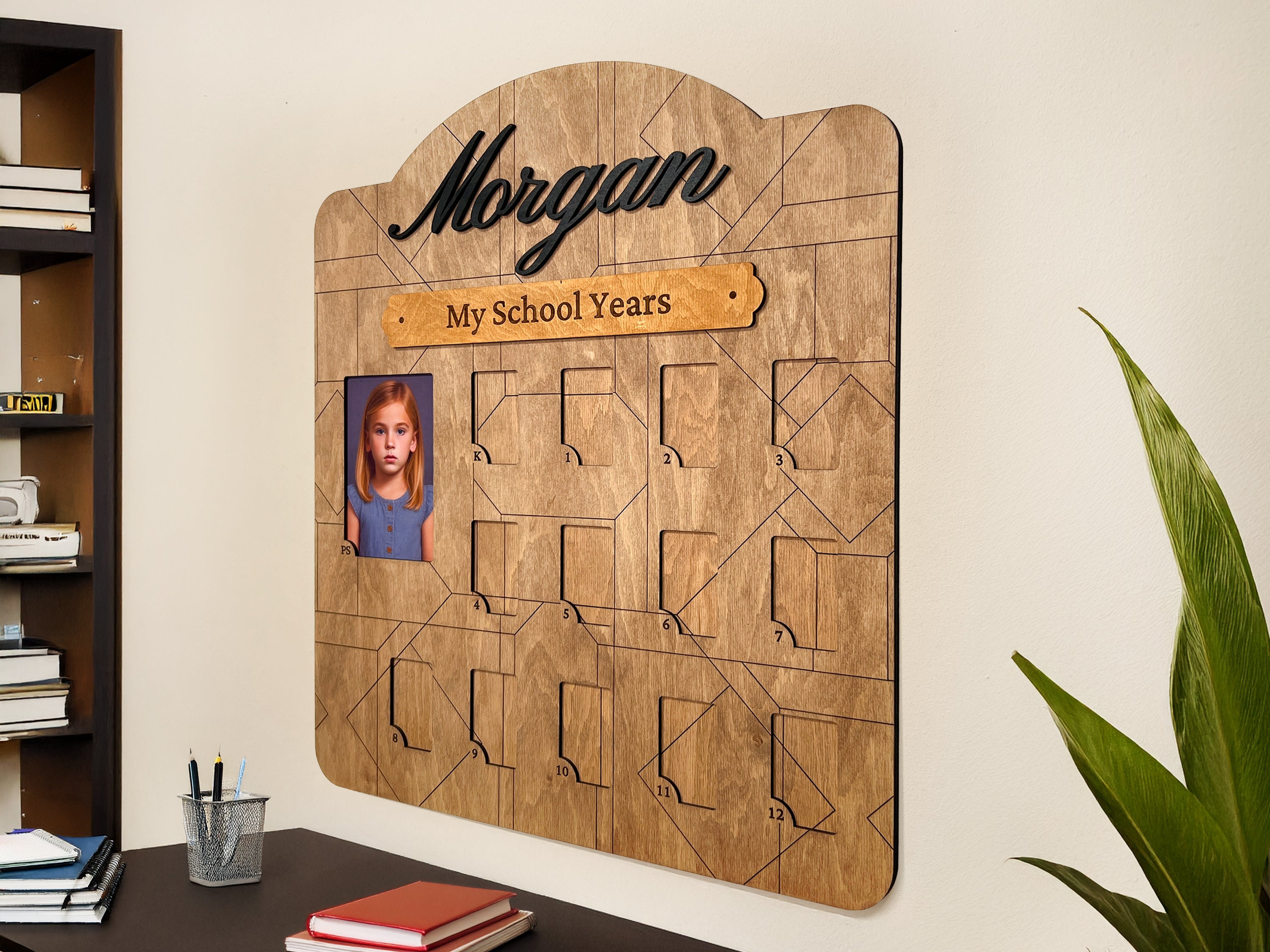 Handcrafted wooden school years photo frame display with personalized name, wall mounted in a home office.