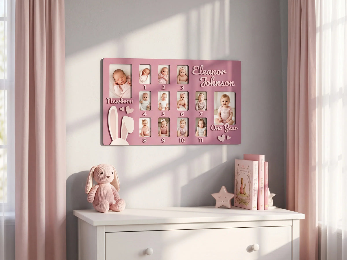 Personalized pink baby first year photo frame by The Frame Depot with monthly milestone photos.