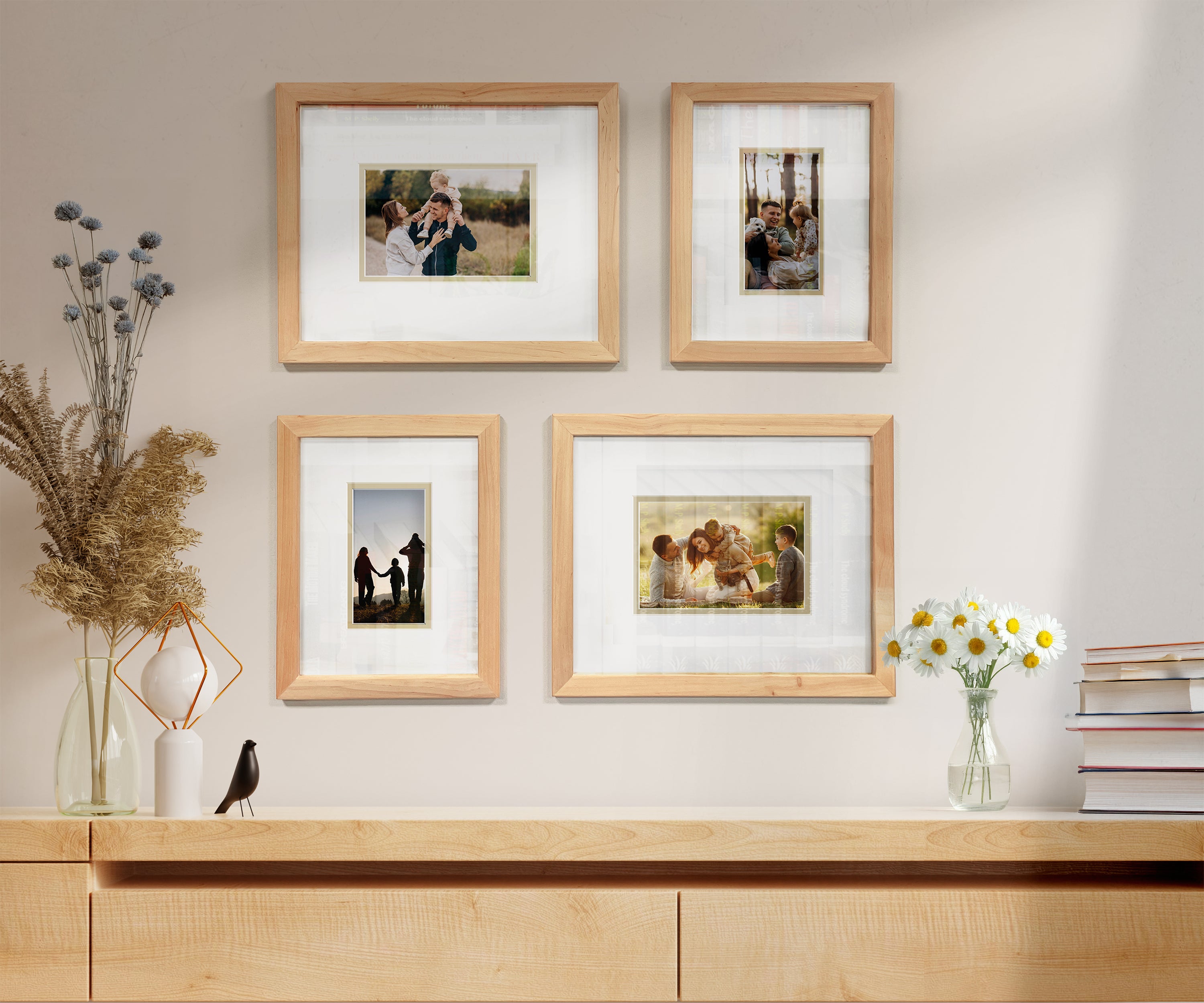 Light wood picture frames with family photos on a modern wall above a wood cabinet.