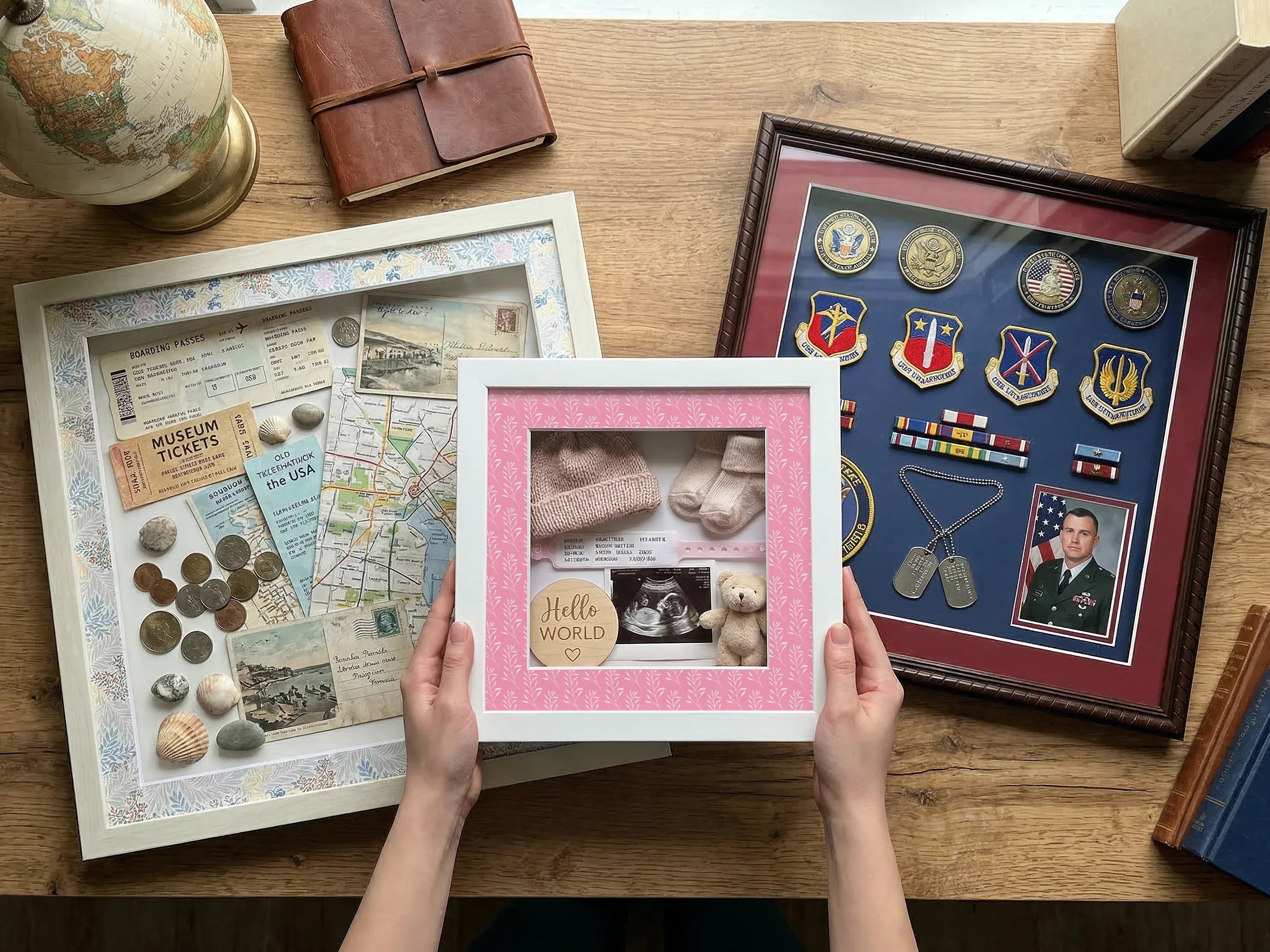 Three different shadow box picture frames displaying special memorabilia on a wooden table.