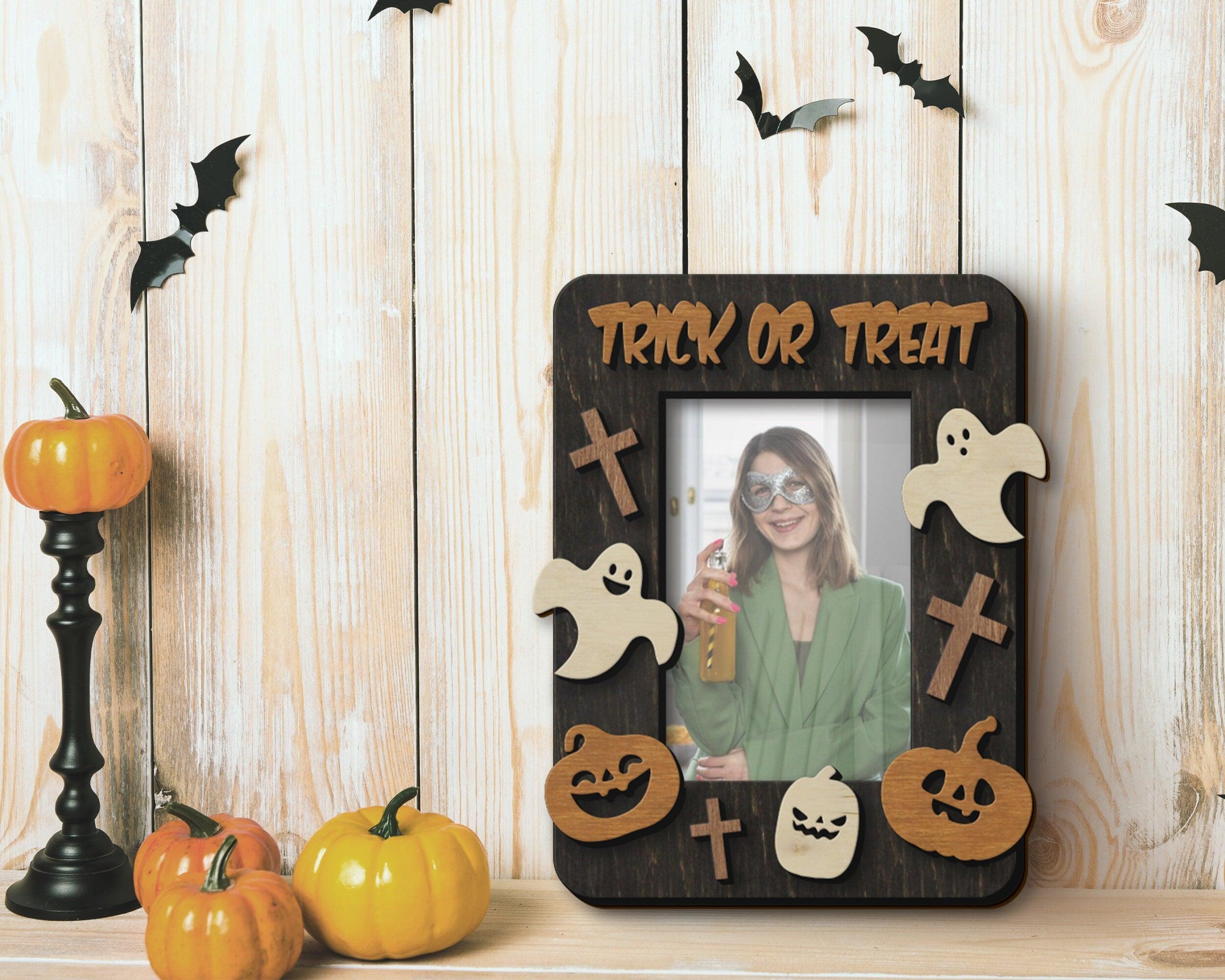 Wooden small vertical single 4 by 6 inches photo frame decorated with crosses, pumpkins and ghosts and a trick or treat text on the top. This frame is 9 by 7 inches. The text and decorations are added as a second layer for a 3d effect.