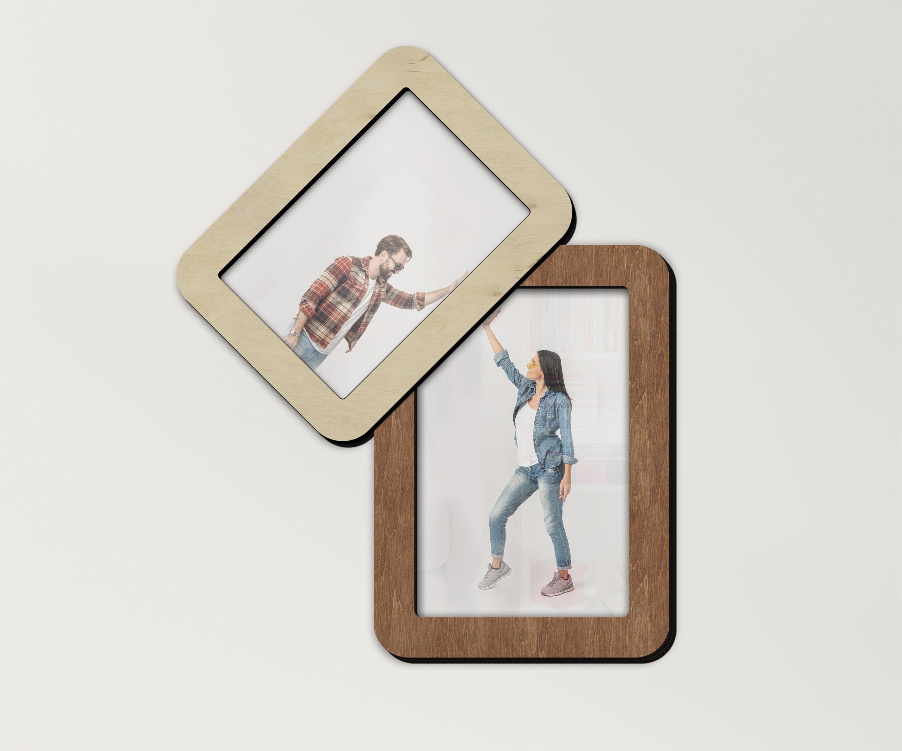 A wooden picture frame collage consisting of two frames - one vertical and other located on the top left corner of the vertical frame, at an angle. Available in 3 sizes and 6 colors. Each frame can be painted independently.